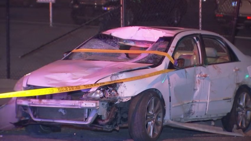 A vehicle sits wrapped in crime scene tape after a person was killed in a hit-and-run along 12th Street and Lehigh Ave, early Sunday by a driver who fled the scene, police said.