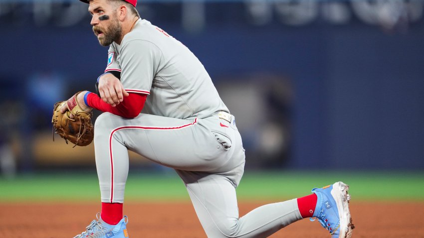 TORONTO, ON – JUNE 4: Bryce Harper #3 of the Philadelphia Phillies kneels in a break in play against the Toronto Blue Jays in their MLB game at the Rogers Centre on June 4, 2025 in Toronto, Ontario, Canada. (Photo by Mark Blinch/Getty Images)