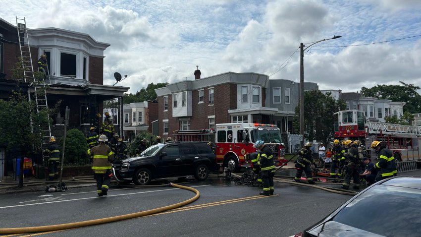 Firefighters respond to a fire near 57th Street and Walton Ave. in the Cobbs Creek section of West Philadelphia on Sunday morning.